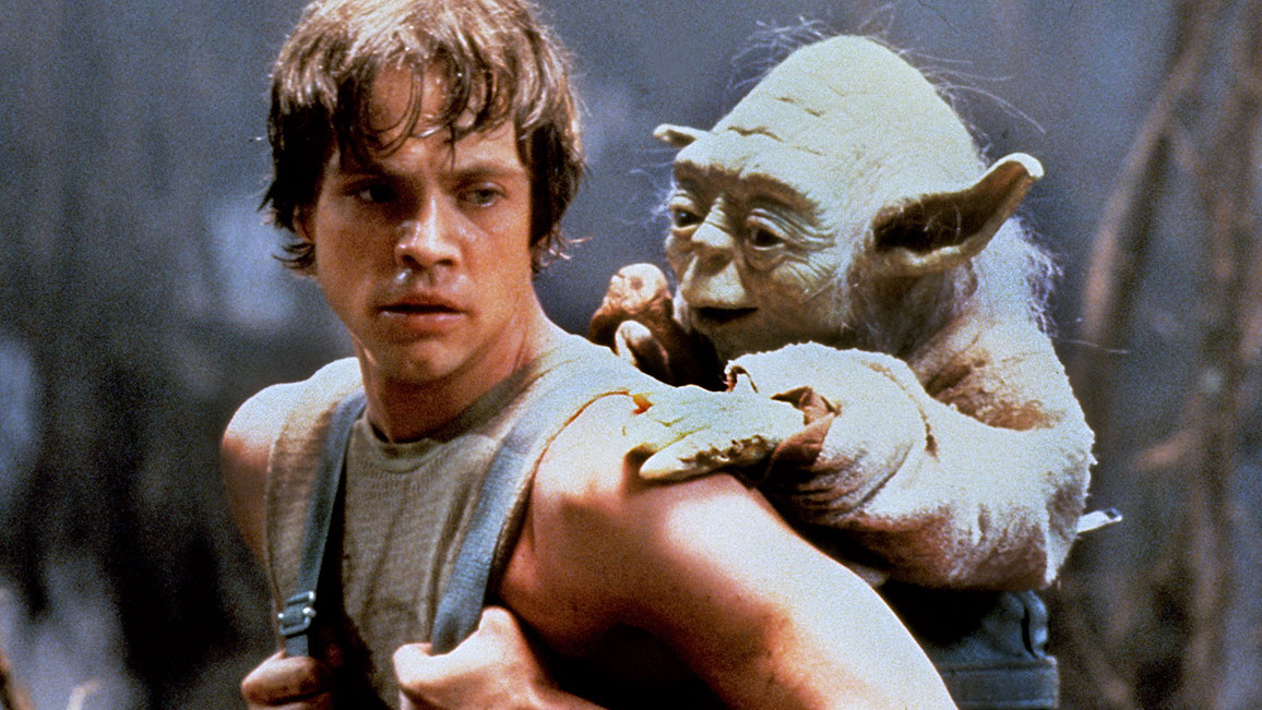 Luke Skywalker carrying Yoda on his back