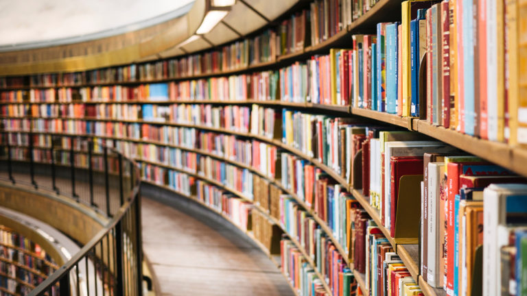 A curving row of bookshelves in a library.